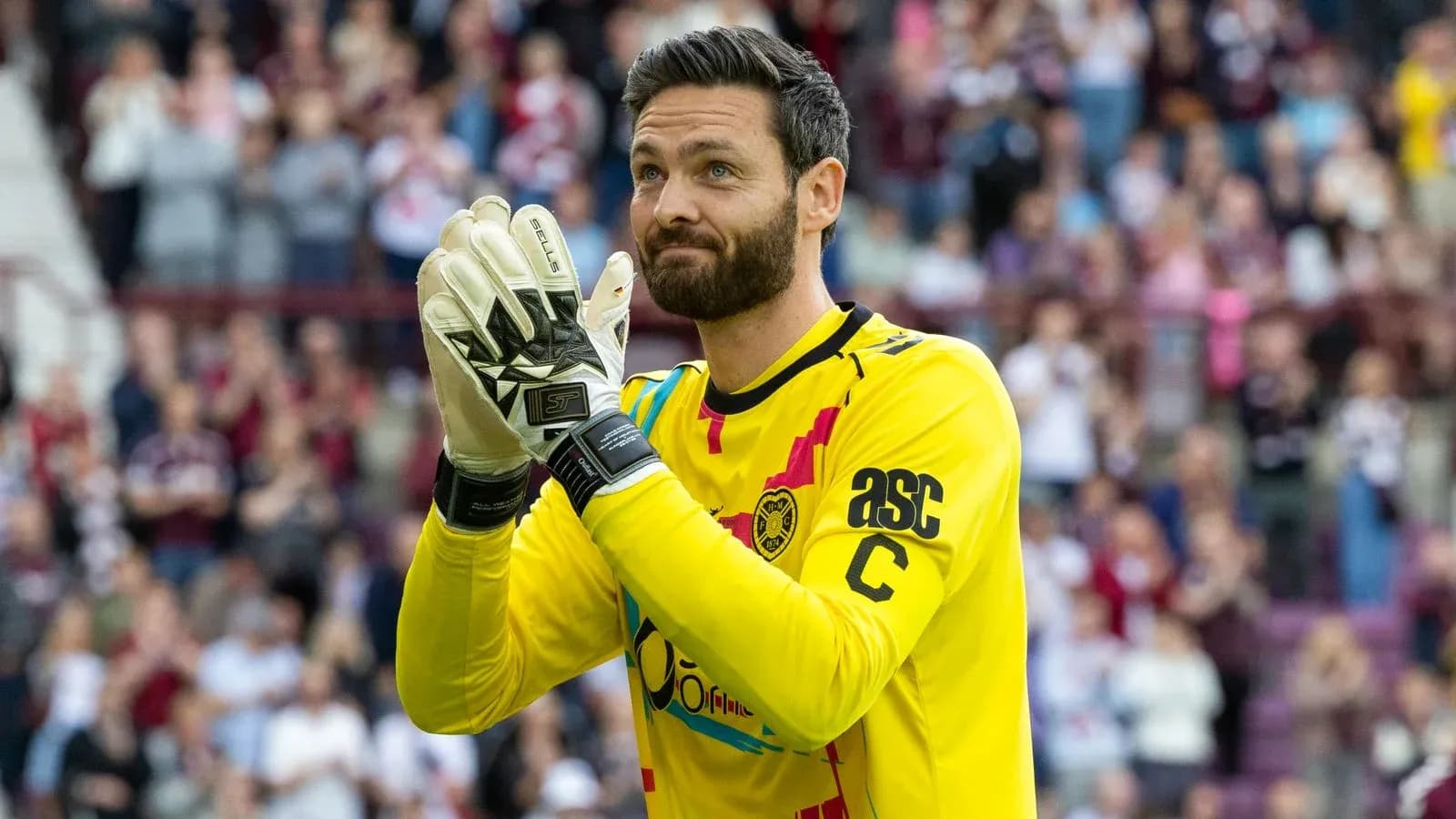 Goalkeeper applauding fans in yellow jersey Goalkeeper applauding fans in yellow jersey