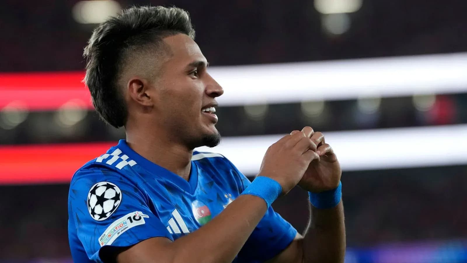 Player celebrating during a UEFA Champions League match Player celebrating during a UEFA Champions League match