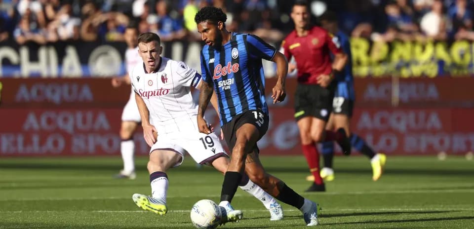 Atalanta player dribbling past Bologna defender Atalanta player dribbling past Bologna defender