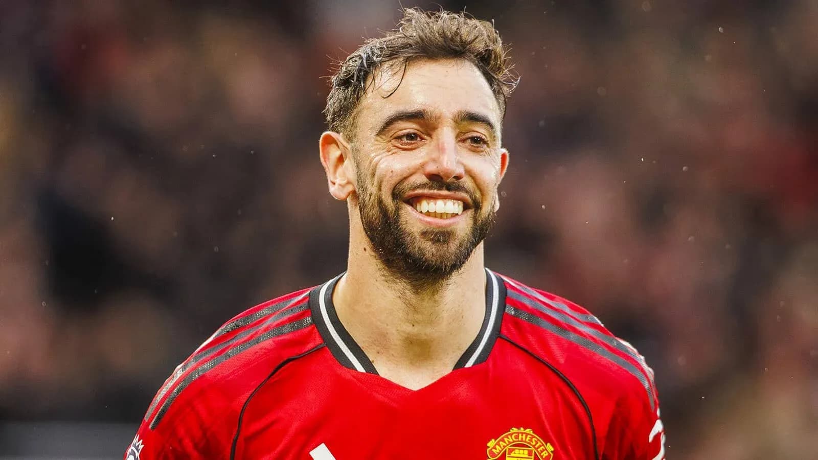 Player smiling in Manchester United red jersey Player smiling in Manchester United red jersey