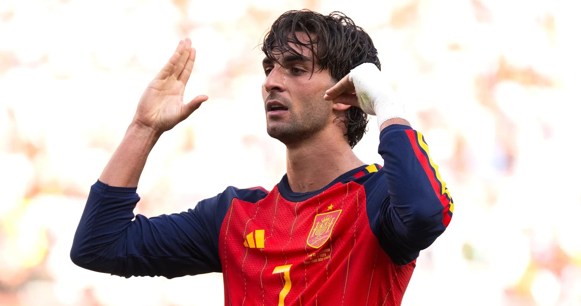 Player signaling during a football match wearing Spain jersey Player signaling during a football match wearing Spain jersey