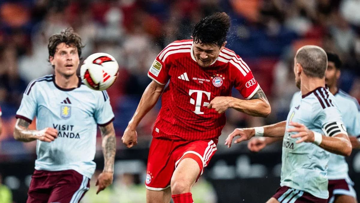 Bayern player heading the ball during match action Bayern player heading the ball during match action
