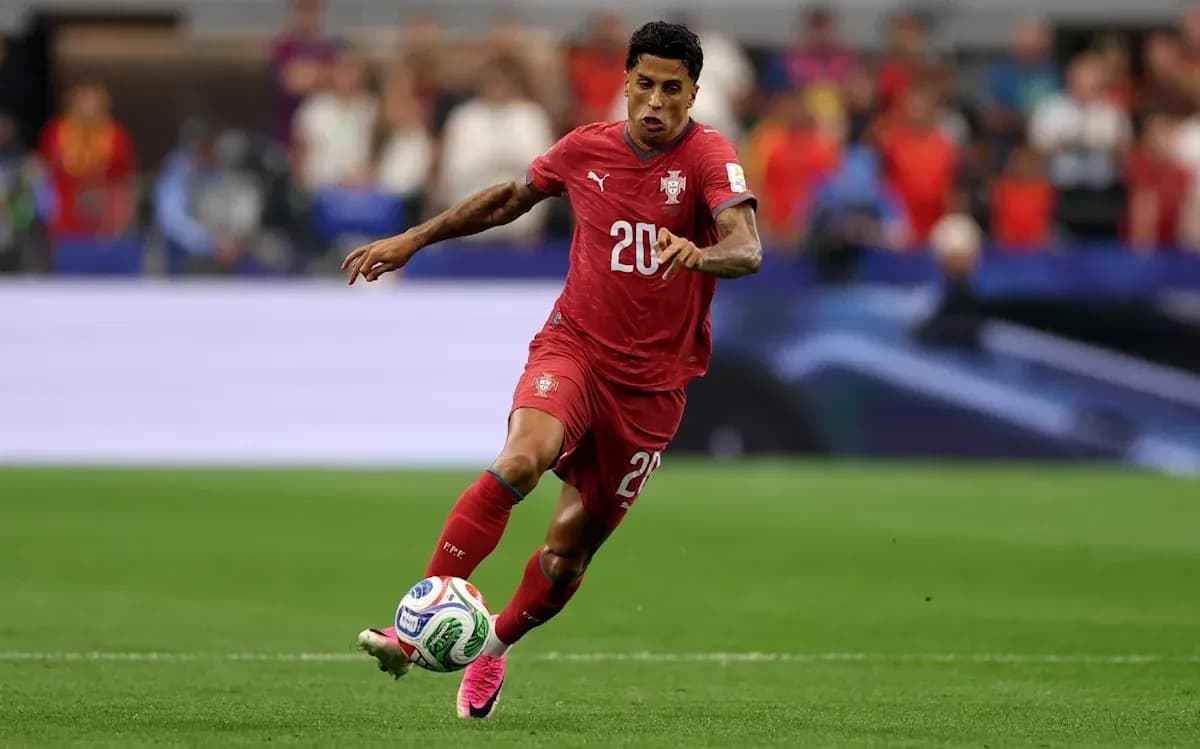 Player in red jersey dribbling the ball on field Player in red jersey dribbling the ball on field