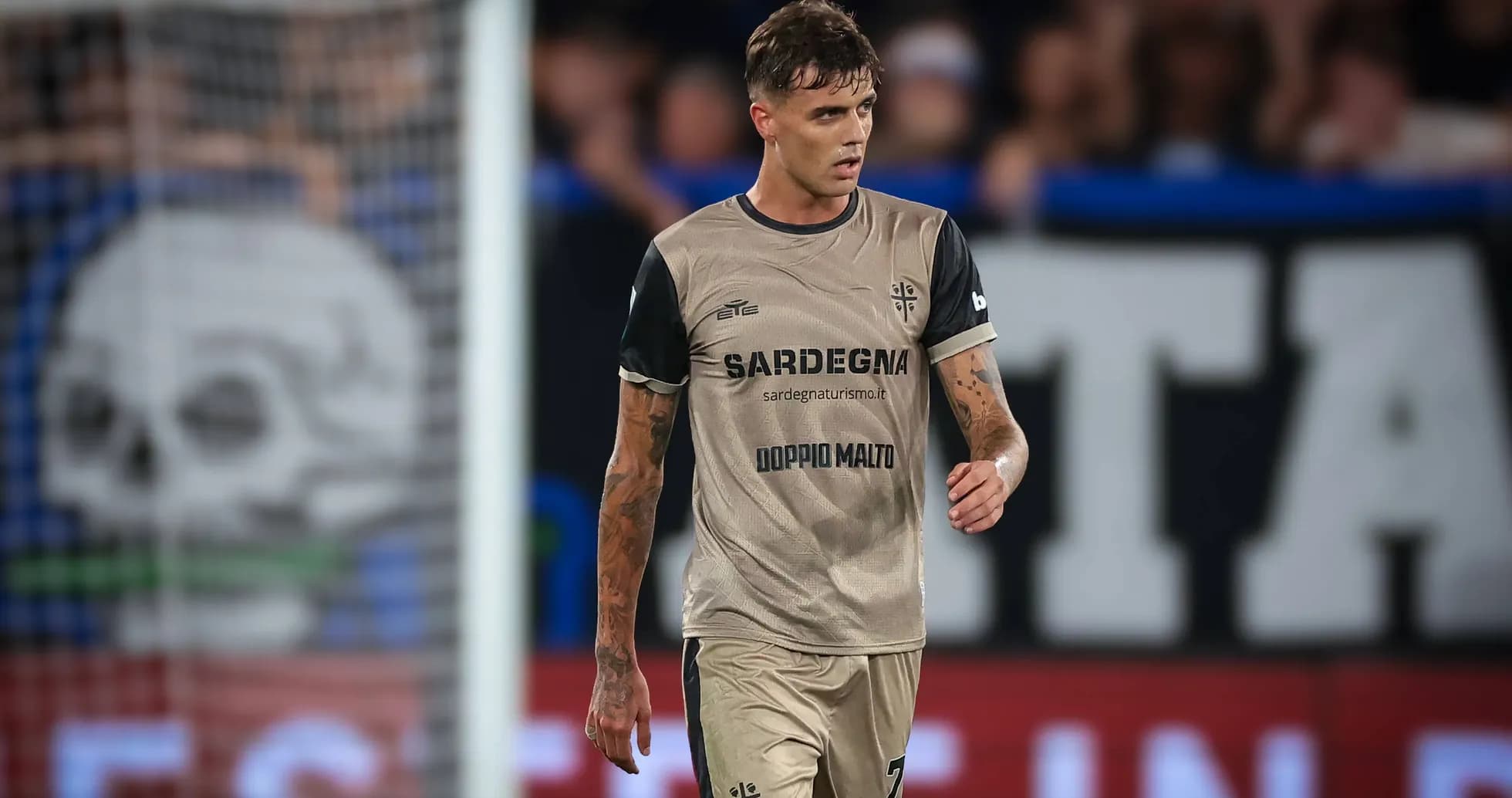 Player in beige jersey walking on the pitch Player in beige jersey walking on the pitch
