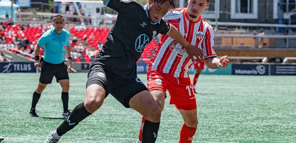 HFX Wanderers FC player tackling Atlético Ottawa player HFX Wanderers FC player tackling Atlético Ottawa player