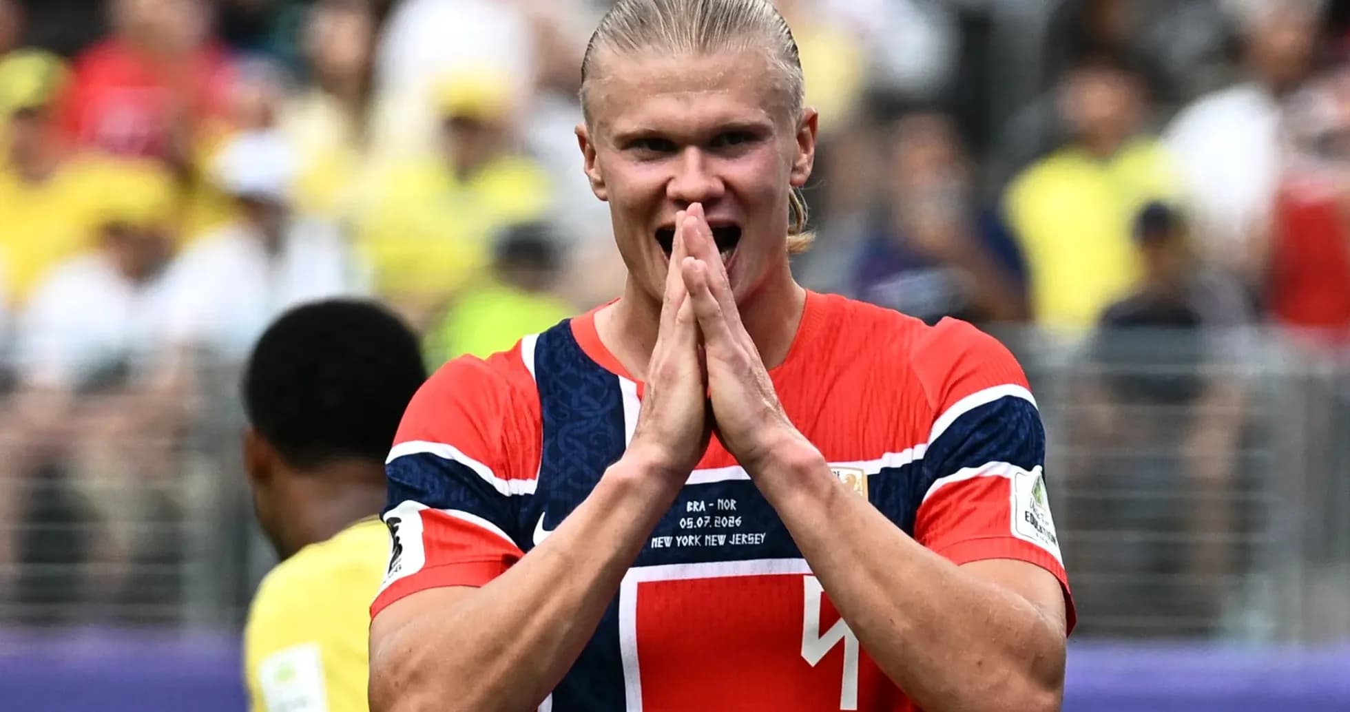 Player celebrating during match with fans in background Player celebrating during match with fans in background