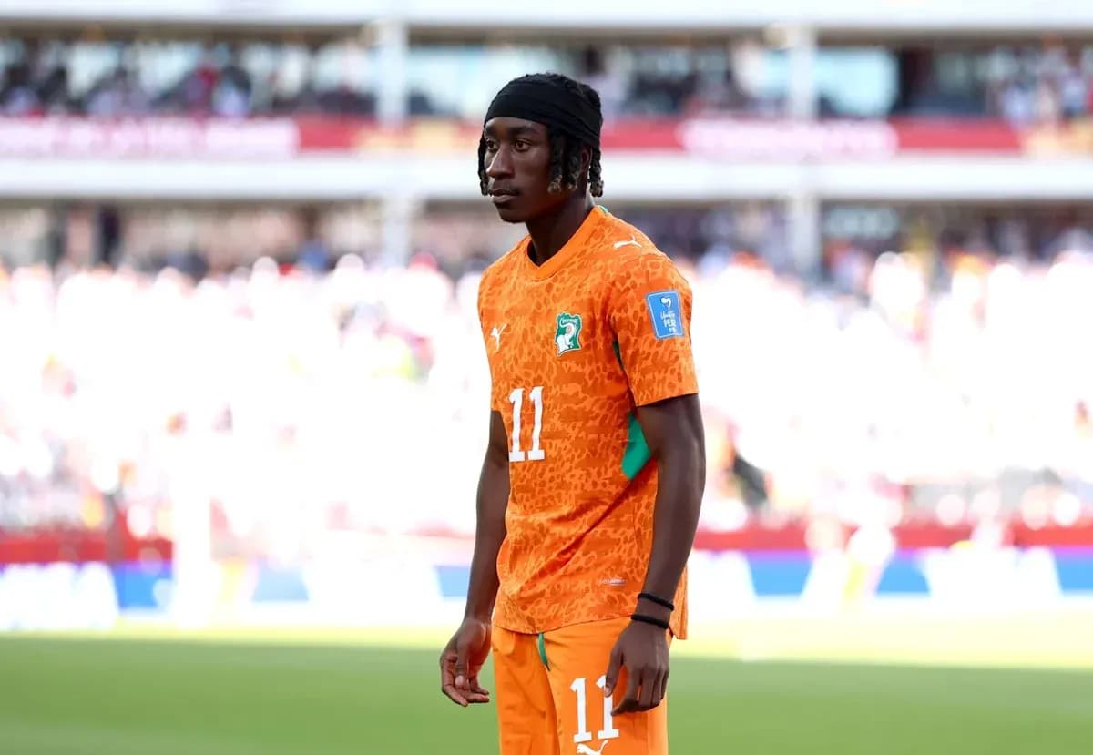 Player wearing orange jersey during warm-up on field Player wearing orange jersey during warm-up on field