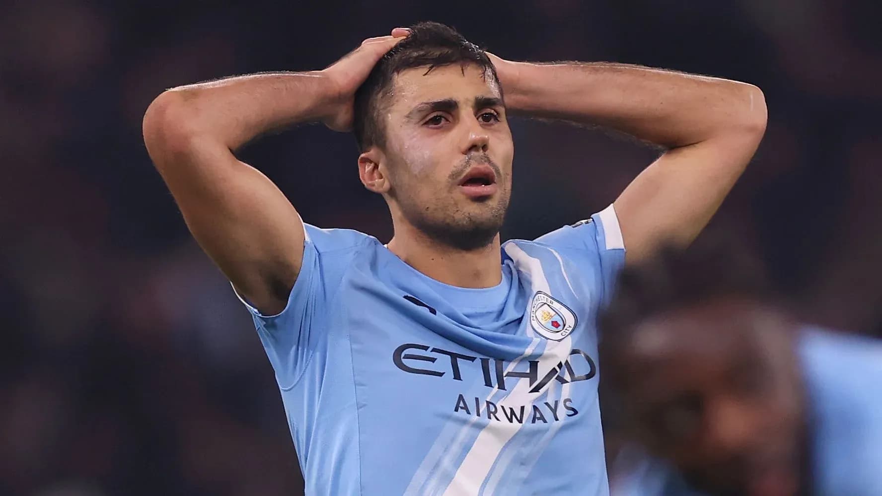 Player holding head in disappointment on the pitch Player holding head in disappointment on the pitch