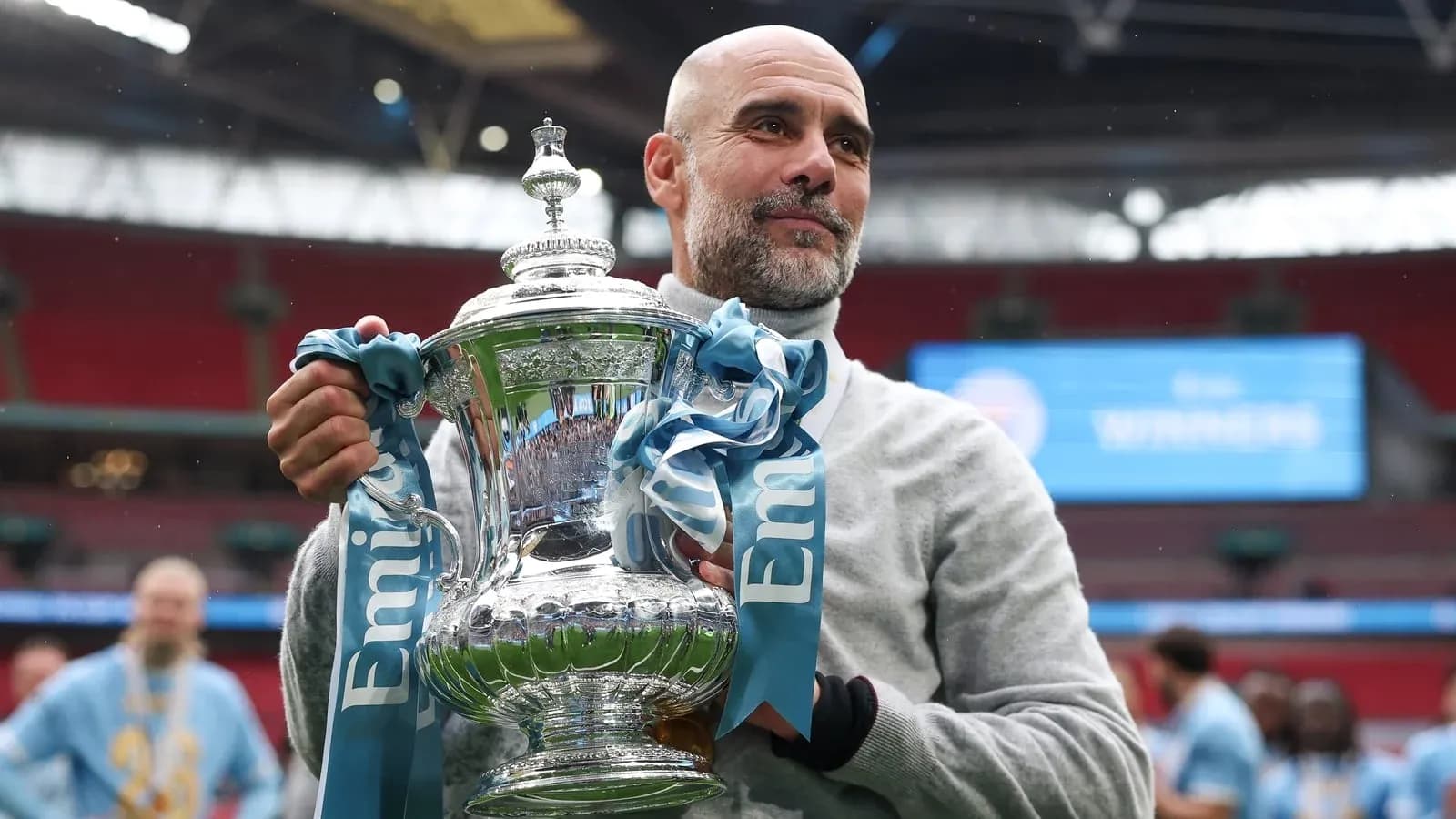 Coach holding trophy at Wembley Stadium celebration Coach holding trophy at Wembley Stadium celebration