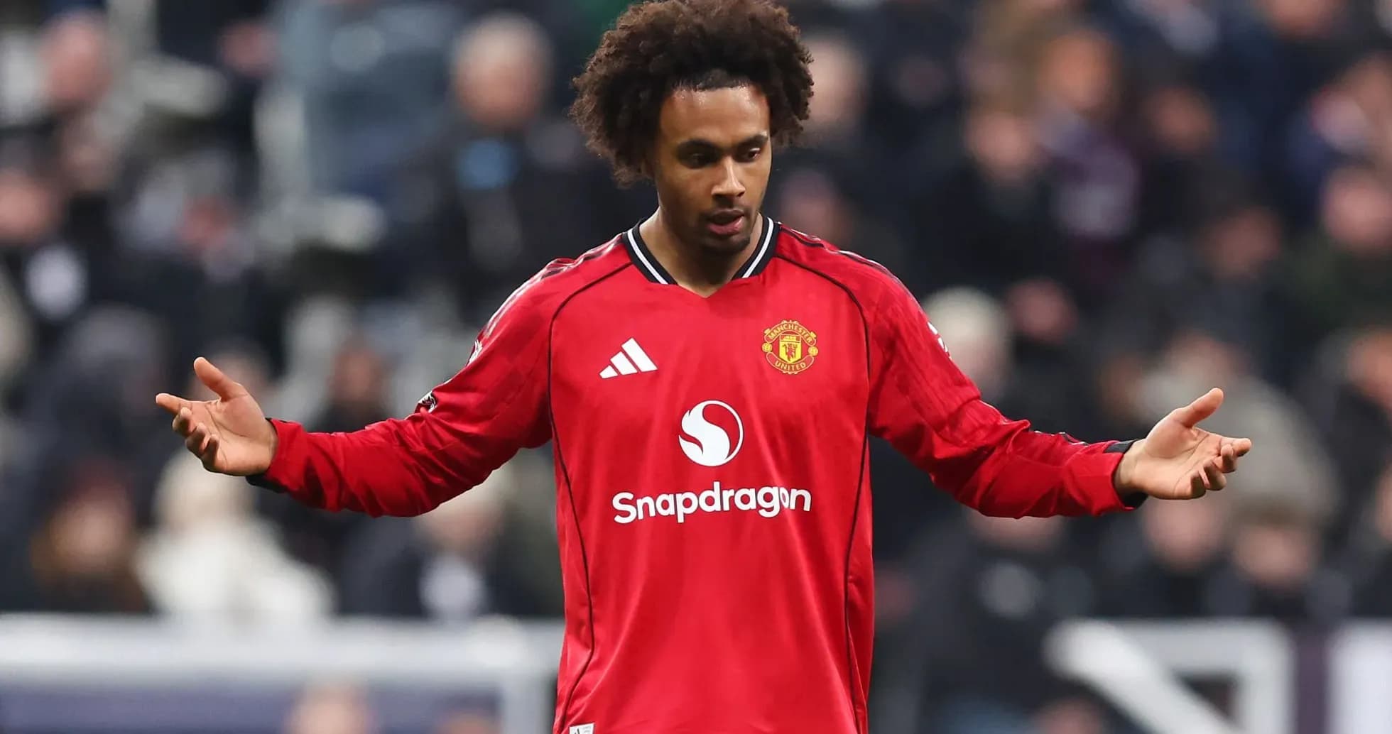 Player in red Manchester United jersey on field Player in red Manchester United jersey on field
