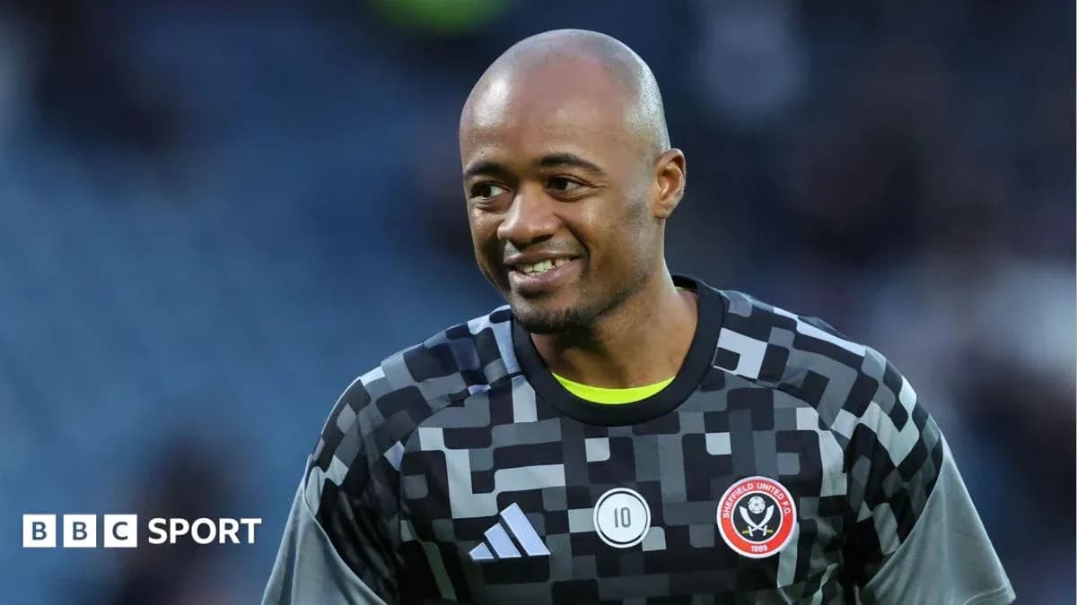 Goalkeeper in Sheffield United kit smiling on pitch Goalkeeper in Sheffield United kit smiling on pitch