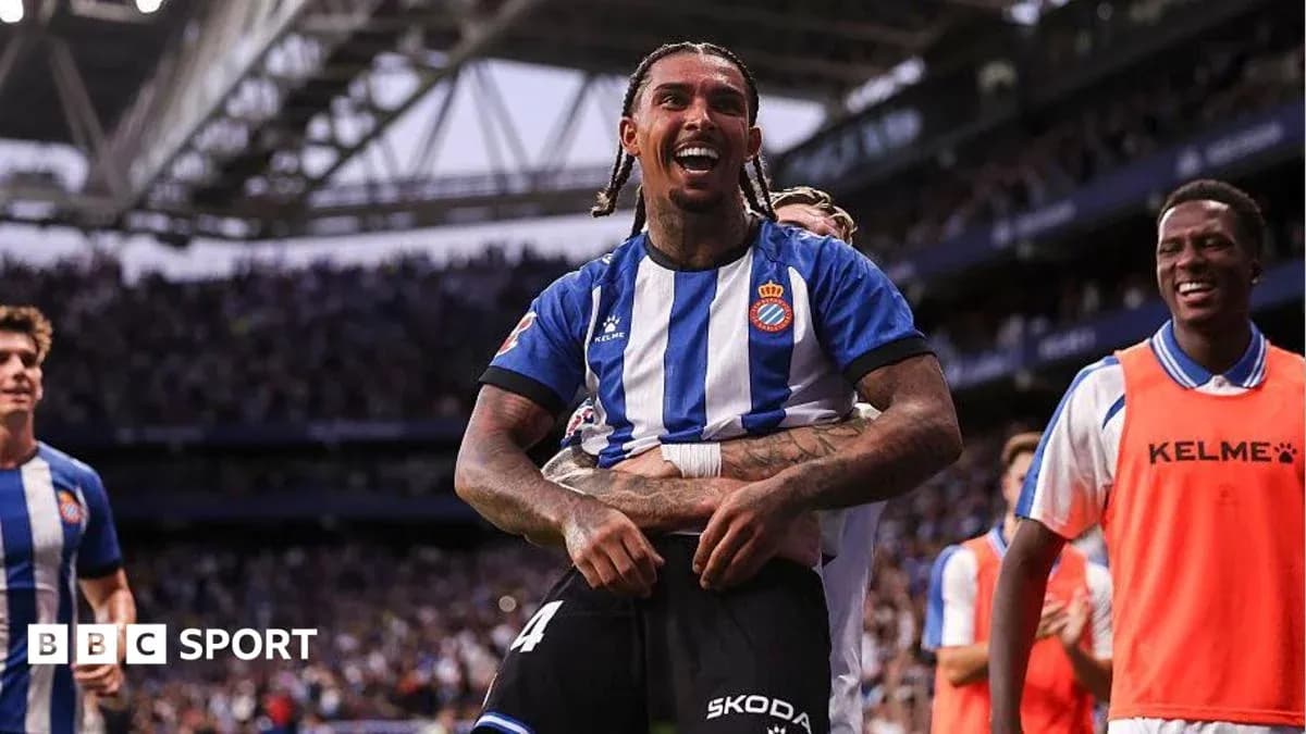 Espanyol player celebrating a goal with teammates Espanyol player celebrating a goal with teammates