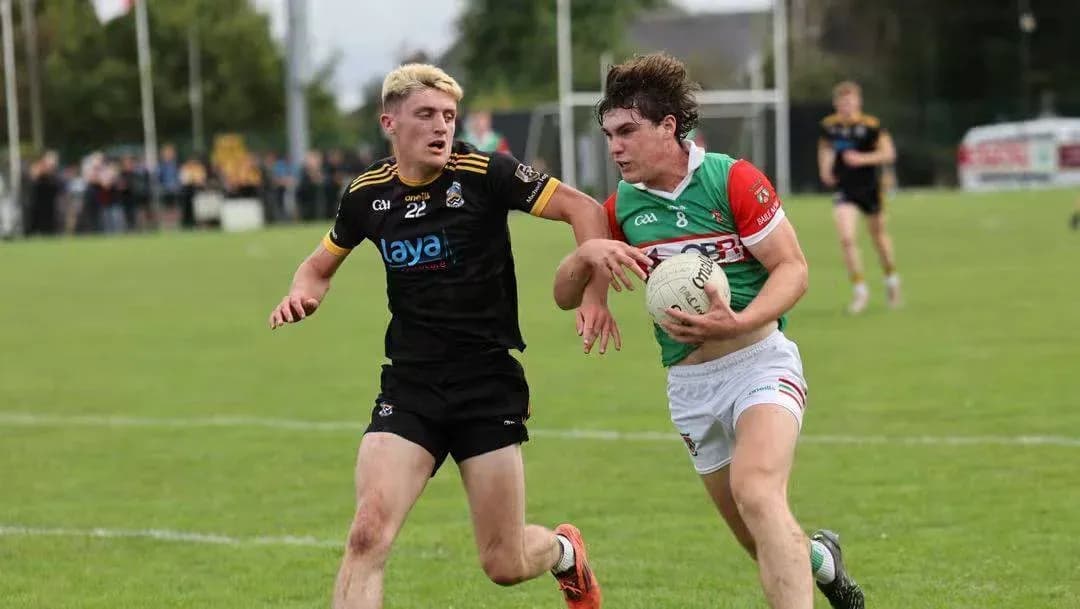 Two players competing for the ball in a match Two players competing for the ball in a match