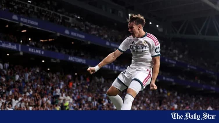 Player celebrating goal in stadium with fans Player celebrating goal in stadium with fans