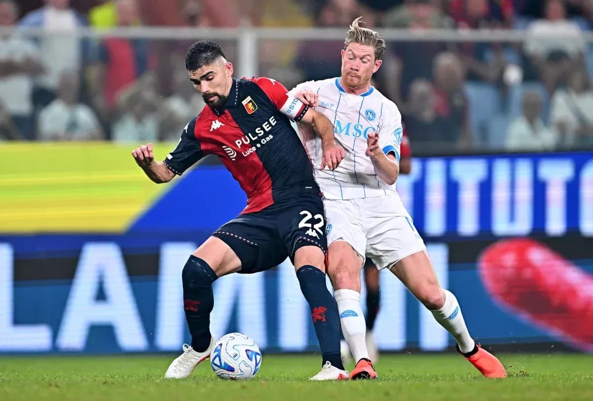Genoa player tackles Napoli player during match Genoa player tackles Napoli player during match