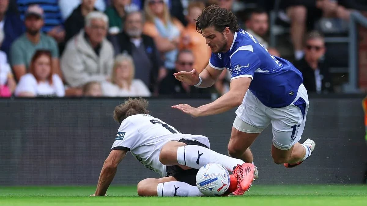 Player tackling opponent during football match action Player tackling opponent during football match action
