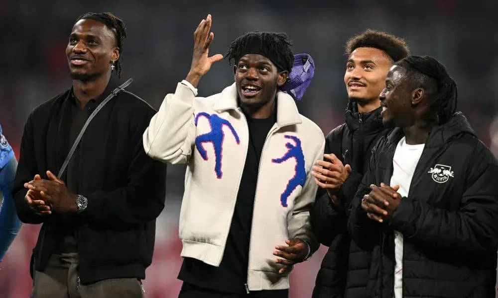Four players interacting on the pitch after match Four players interacting on the pitch after match