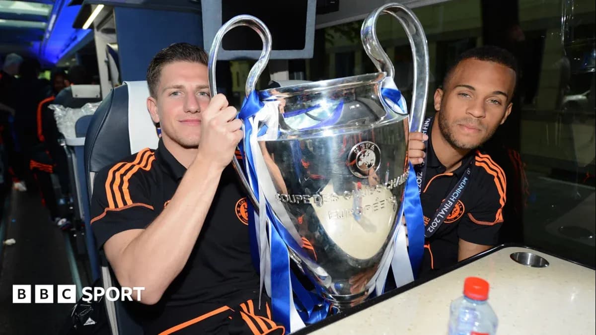 Two players celebrating with UEFA Champions League trophy Two players celebrating with UEFA Champions League trophy