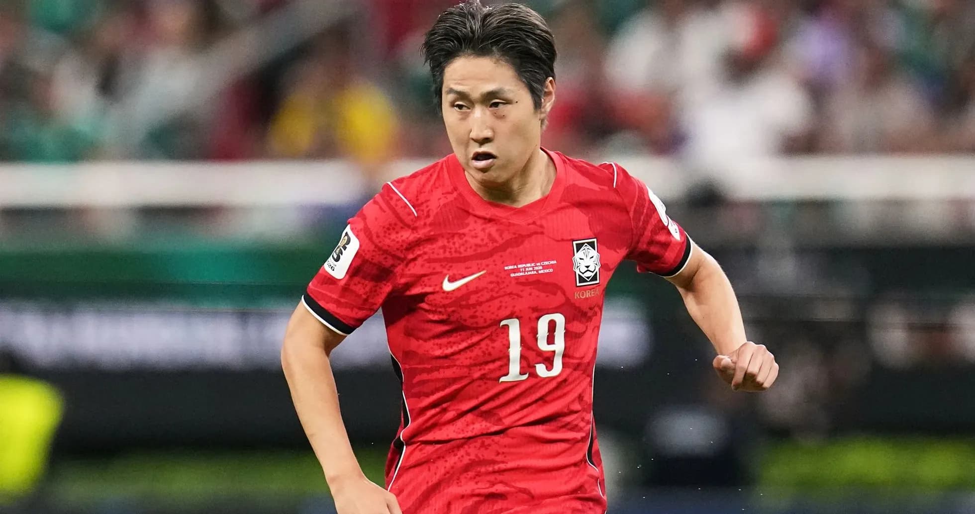 Player wearing red jersey running on the field Player wearing red jersey running on the field