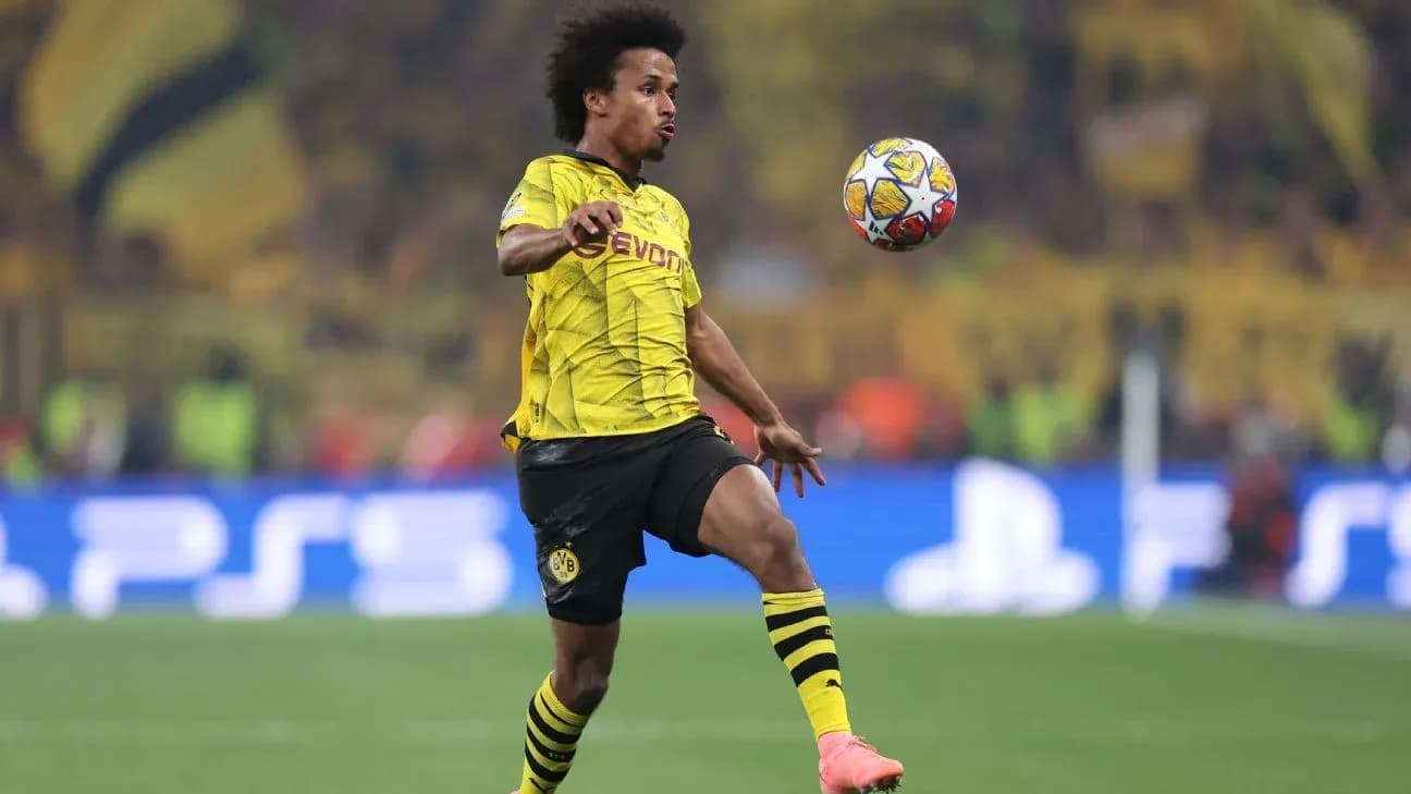 Player in Borussia Dortmund kit controlling the ball Player in Borussia Dortmund kit controlling the ball