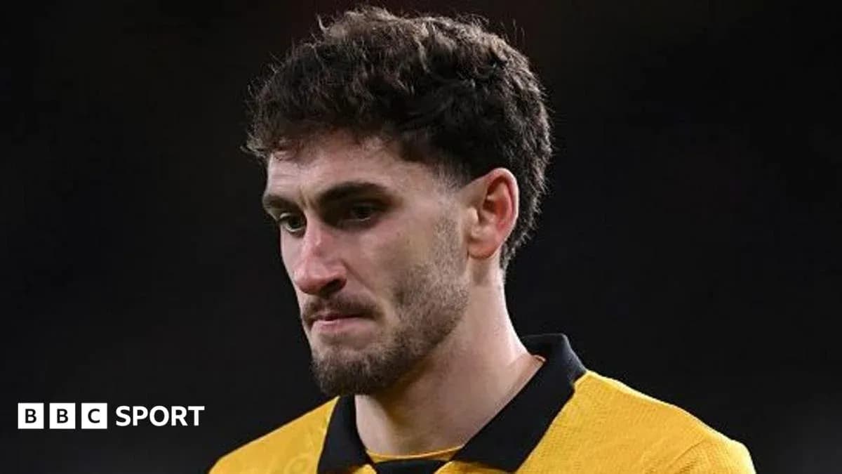 Player in yellow jersey looking thoughtful on field Player in yellow jersey looking thoughtful on field