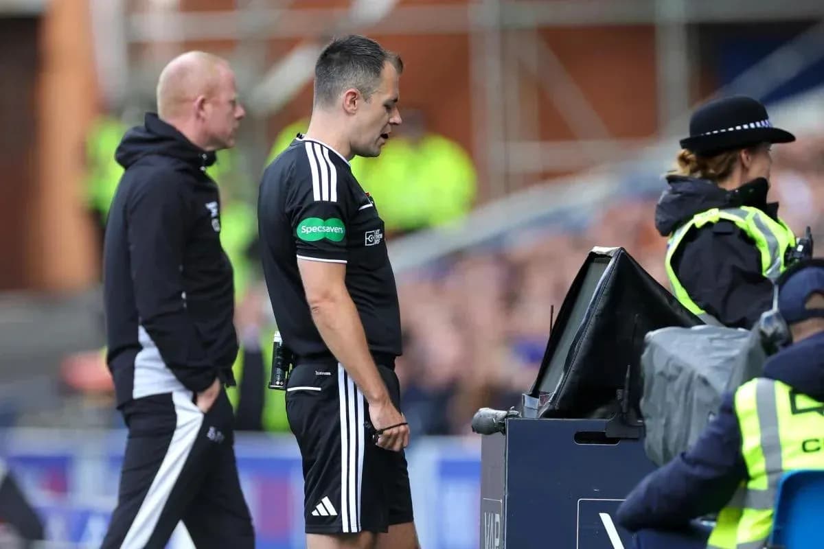 Referee reviewing decision at VAR monitor during match Referee reviewing decision at VAR monitor during match