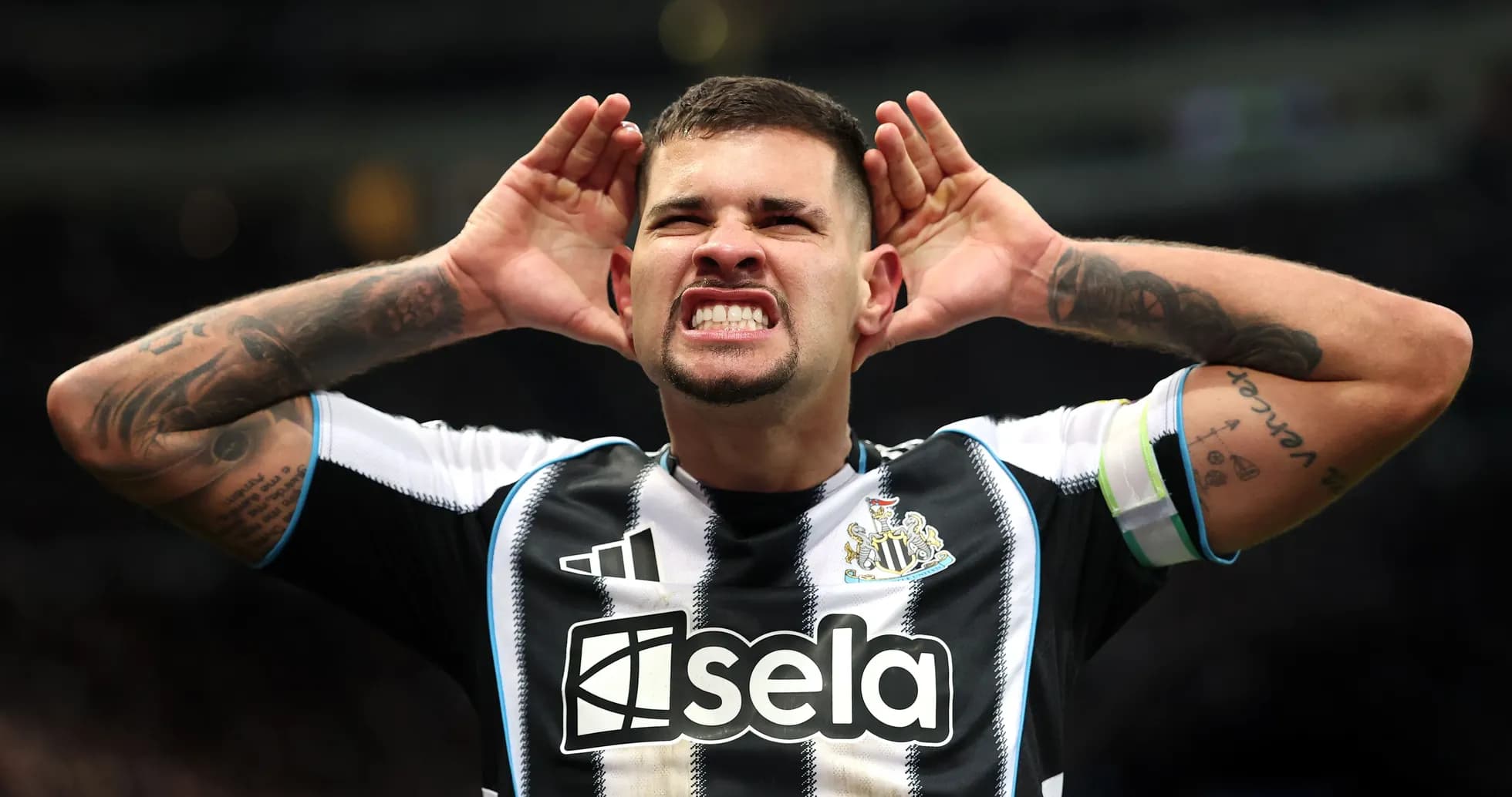 Player celebrating with hands on ears during match Player celebrating with hands on ears during match