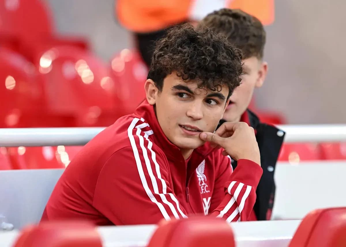 Player in Liverpool FC kit sitting on bench Player in Liverpool FC kit sitting on bench