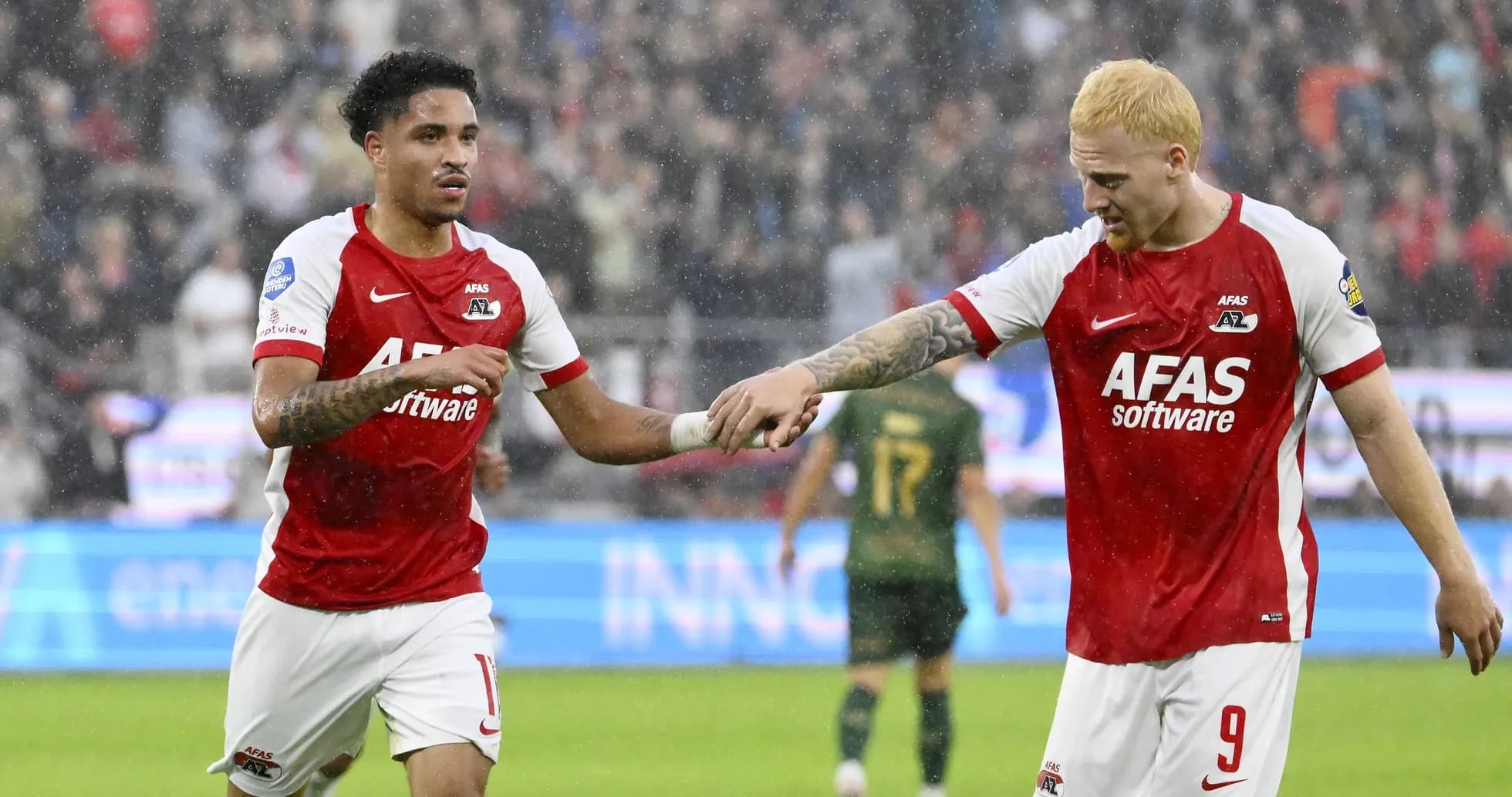 Two AZ Alkmaar players celebrating during a match Two AZ Alkmaar players celebrating during a match