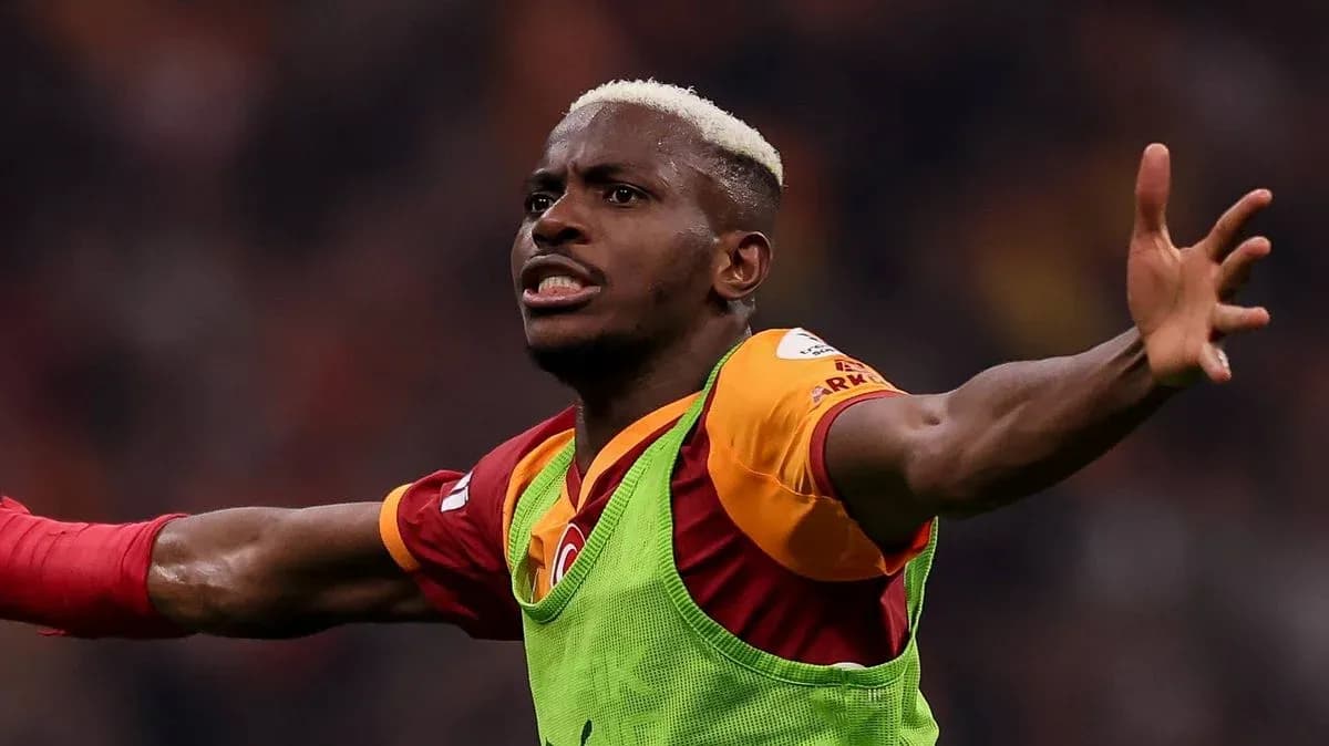 Player celebrating with arms raised in stadium Player celebrating with arms raised in stadium