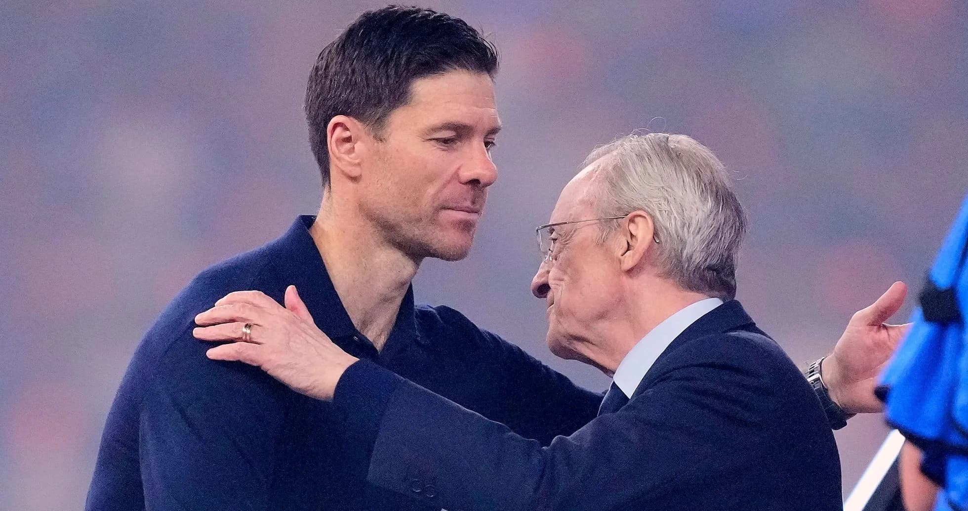 Two men embracing on a sports field Two men embracing on a sports field