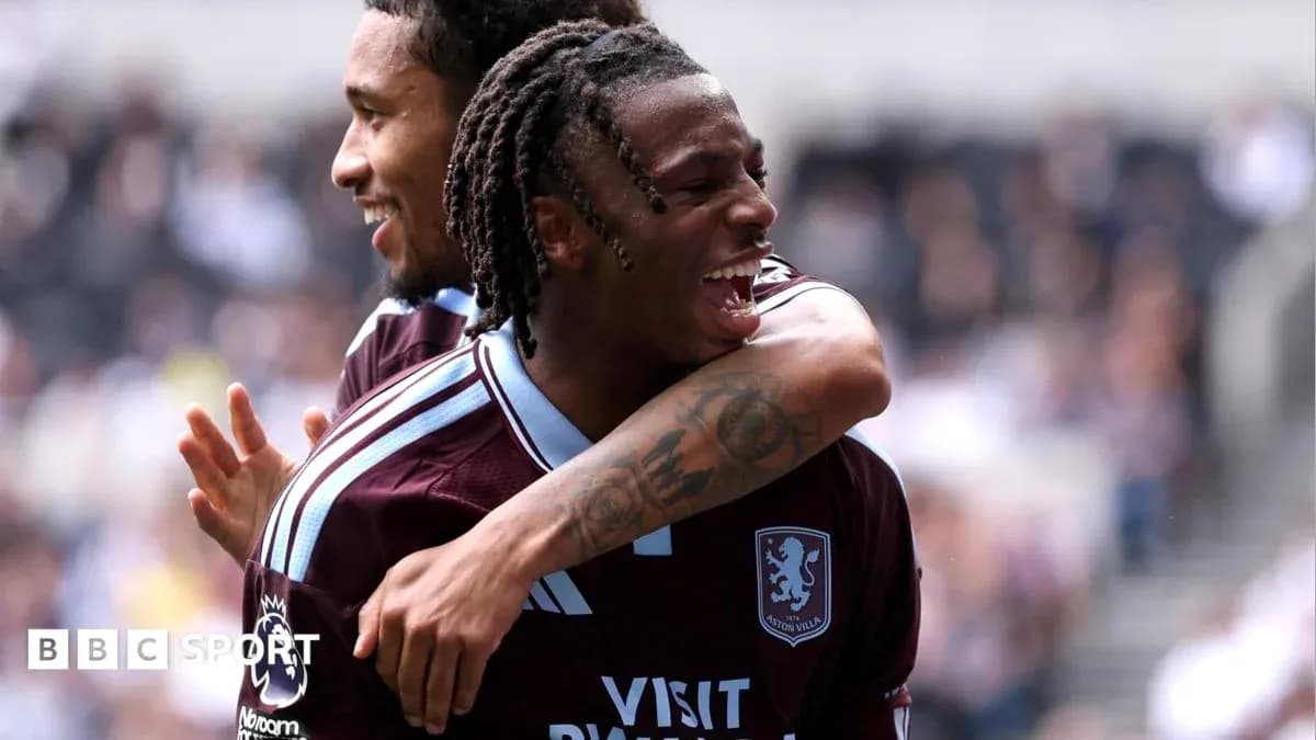 Two Aston Villa players celebrating a goal together Two Aston Villa players celebrating a goal together