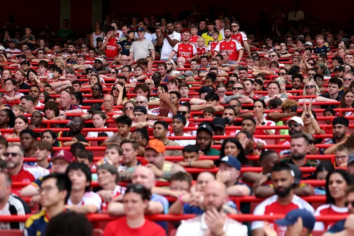 Crowd of Arsenal fans in stadium seats Crowd of Arsenal fans in stadium seats