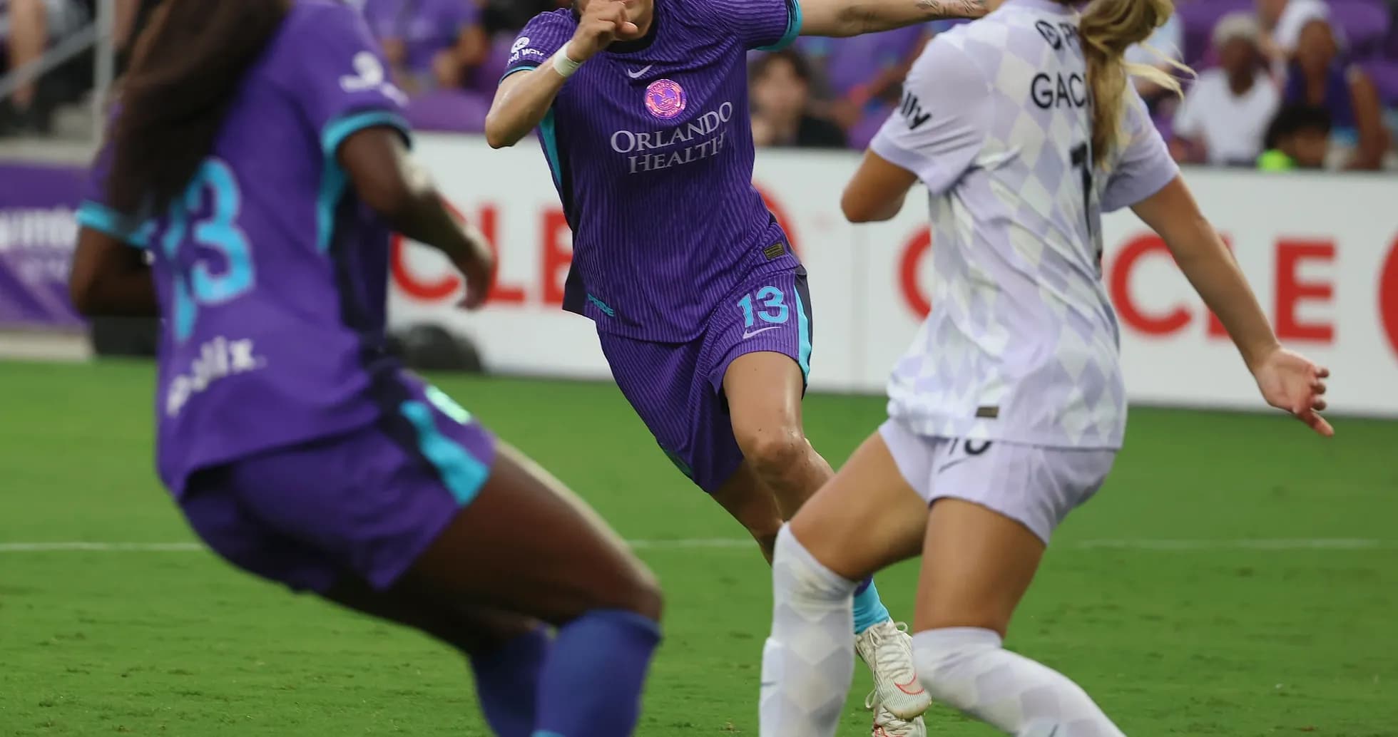 Orlando Pride player challenging Portland Thorns opponent Orlando Pride player challenging Portland Thorns opponent