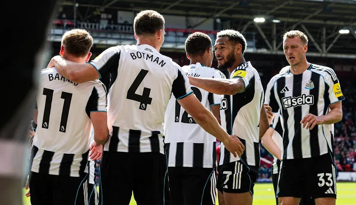 Newcastle players celebrating a goal on the field Newcastle players celebrating a goal on the field