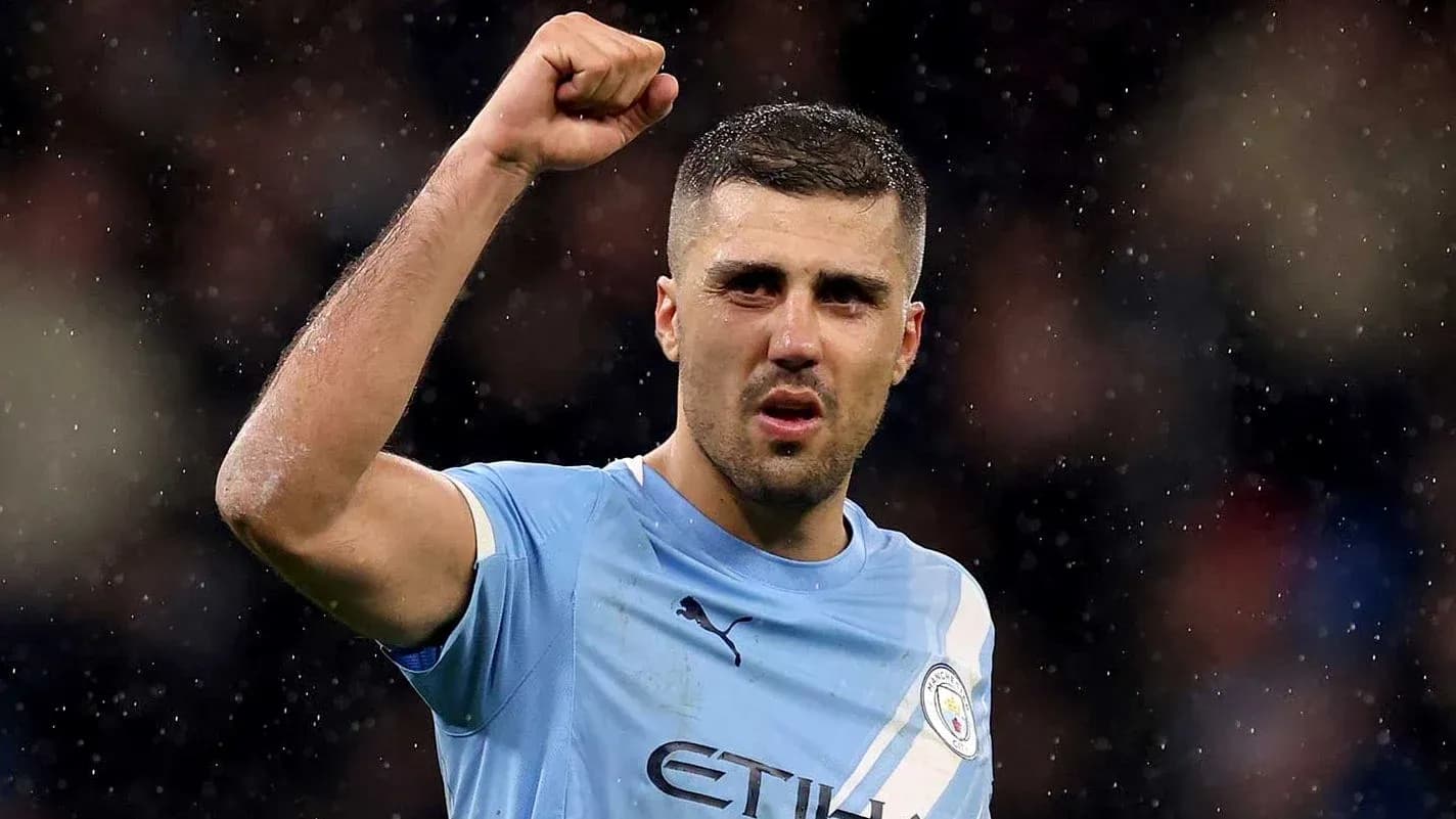 Player celebrating with raised fist on pitch Player celebrating with raised fist on pitch