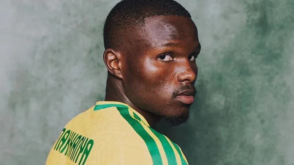 Player wearing yellow jersey against green background Player wearing yellow jersey against green background