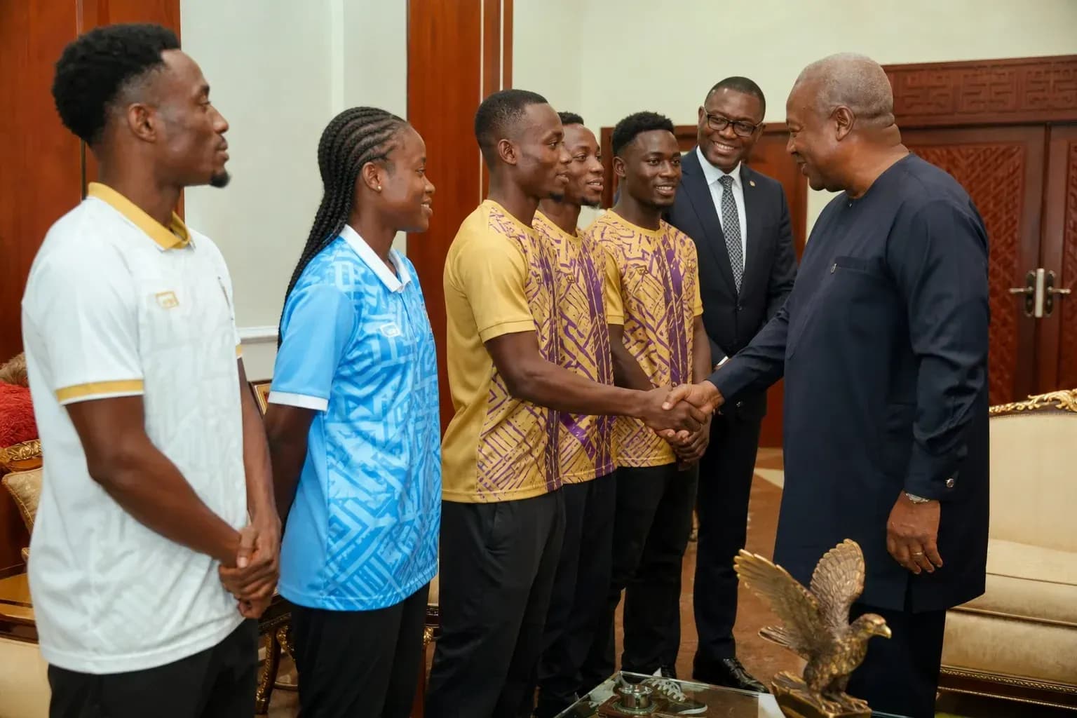Athletes meeting with official in formal setting Athletes meeting with official in formal setting