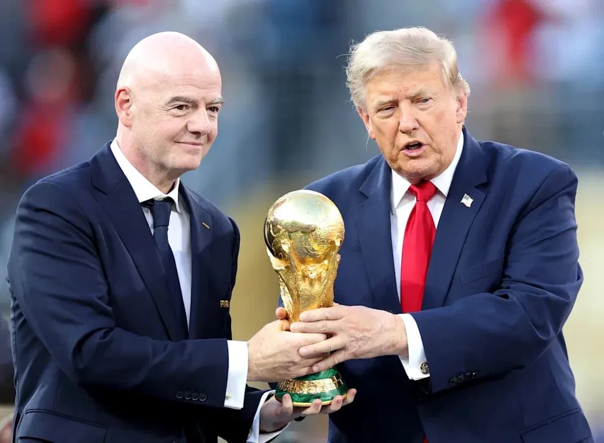 Gianni Infantino and Donald Trump holding World Cup trophy Gianni Infantino and Donald Trump holding World Cup trophy