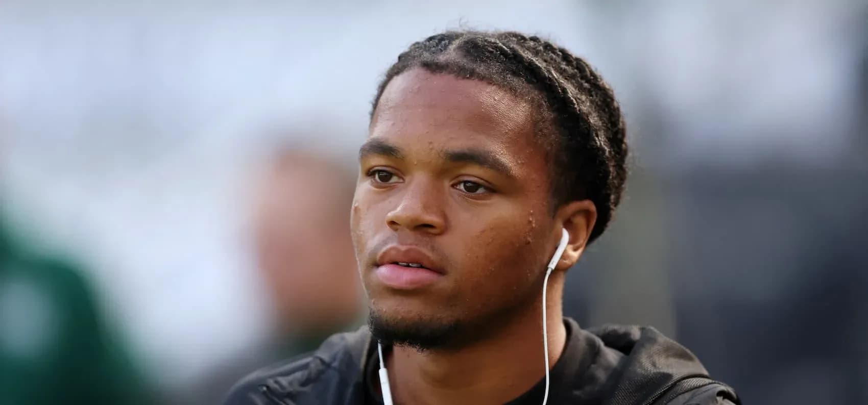 Player with earbuds preparing before the match Player with earbuds preparing before the match