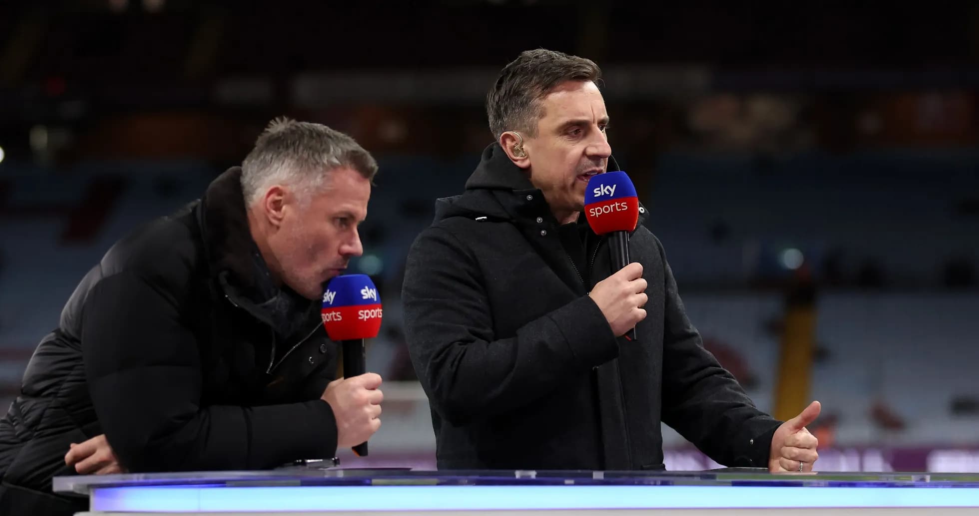 Two sports analysts speaking at a broadcast desk Two sports analysts speaking at a broadcast desk