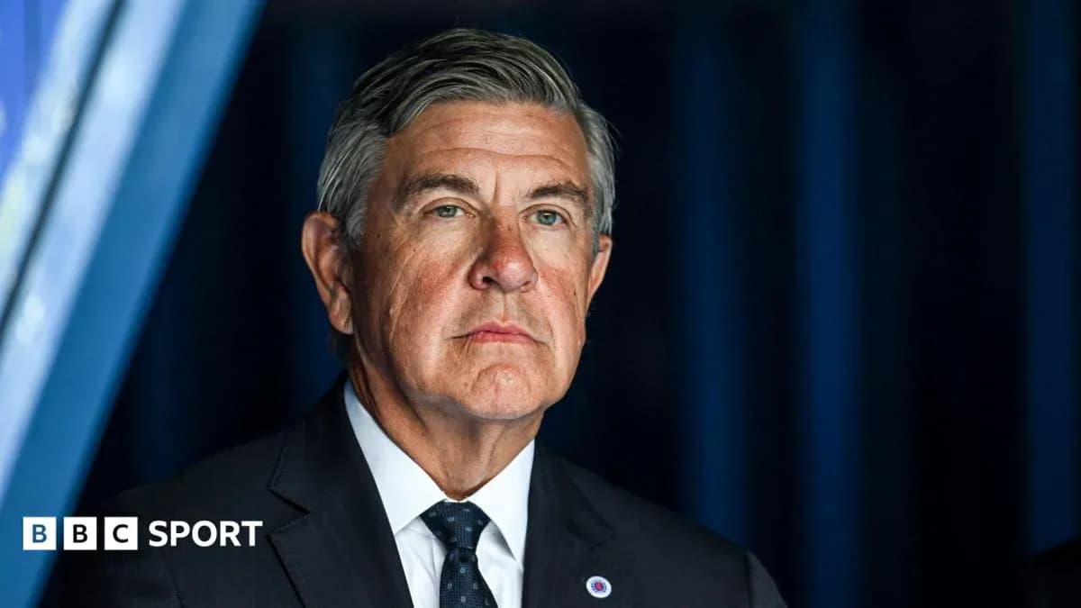 Man in a suit at a press conference backdrop Man in a suit at a press conference backdrop