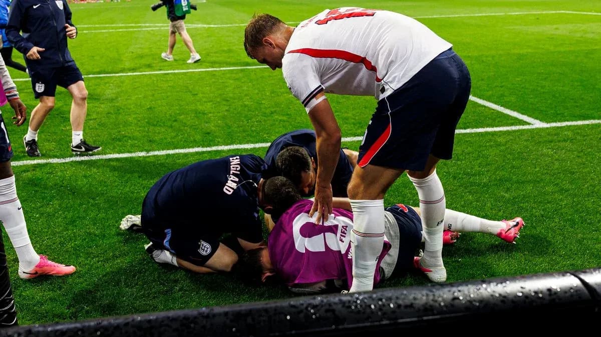 Players attending to injured teammate on the field Players attending to injured teammate on the field