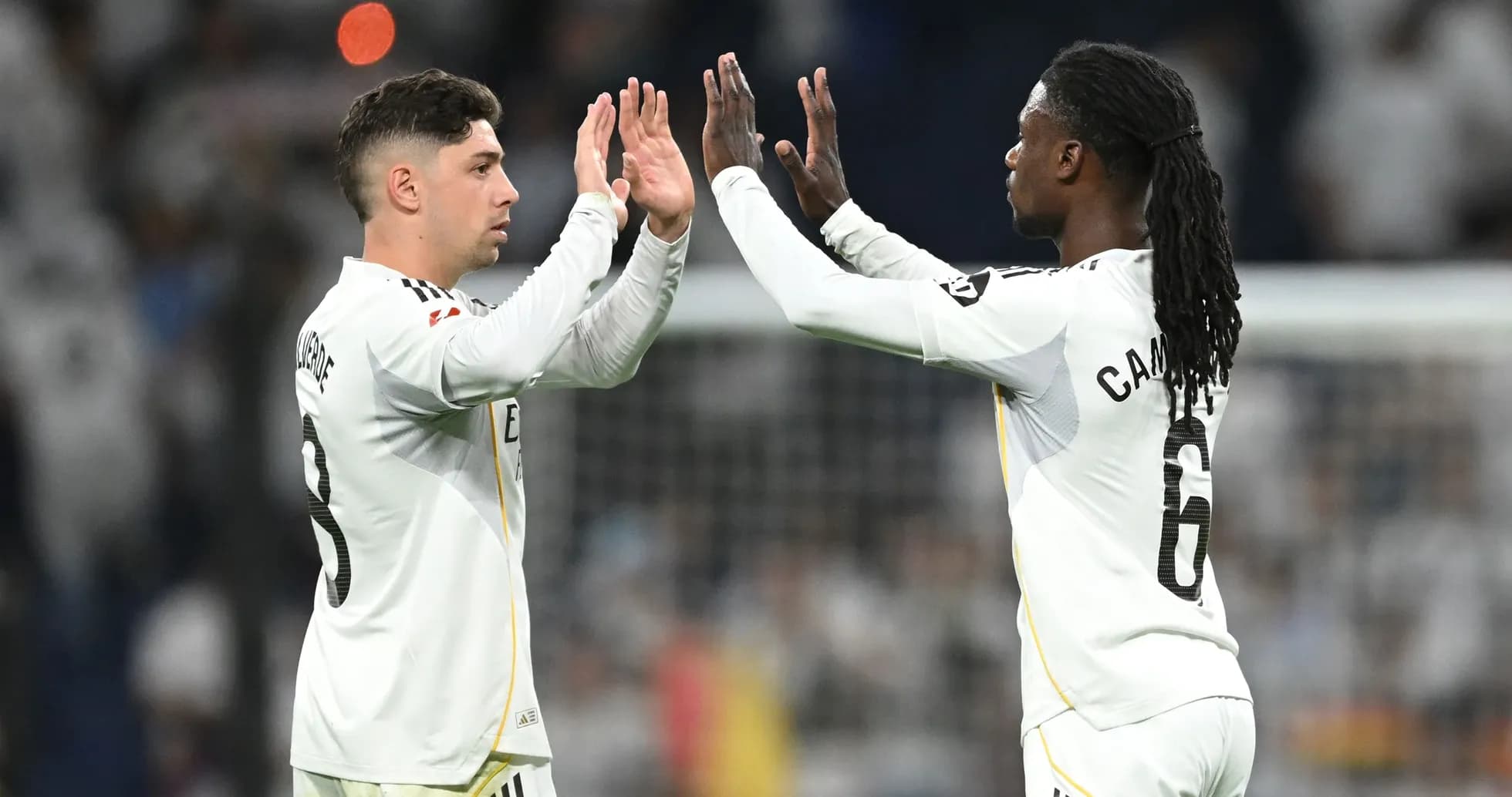 Players high-fiving during a football match Players high-fiving during a football match