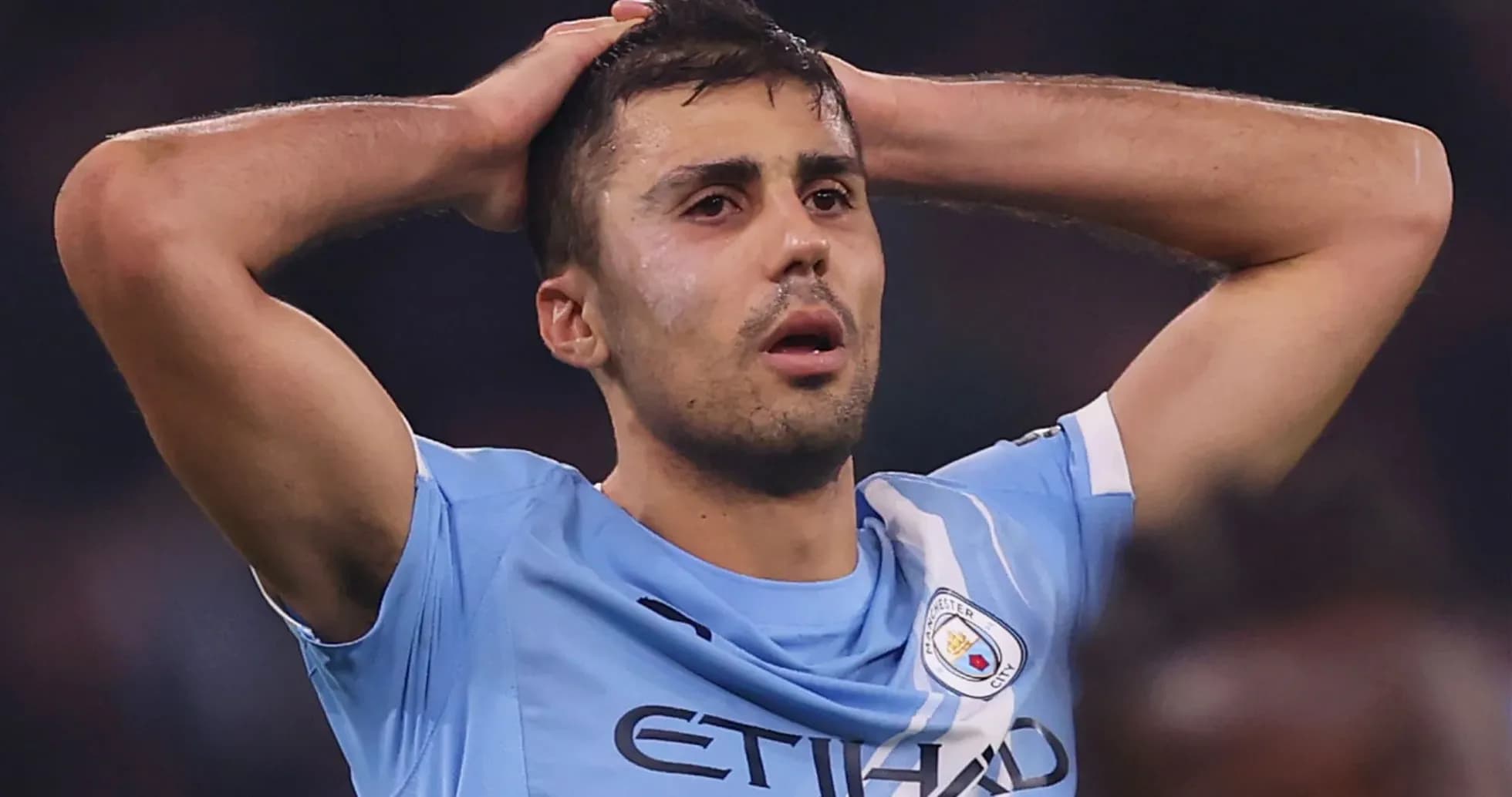 Player holding head in disappointment on the field Player holding head in disappointment on the field