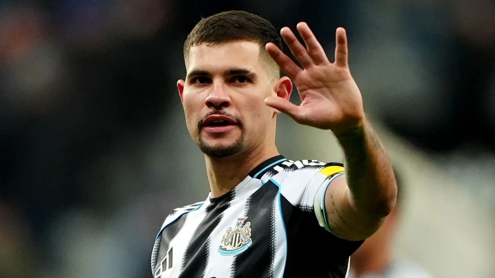 Player waving during a match for Newcastle United Player waving during a match for Newcastle United