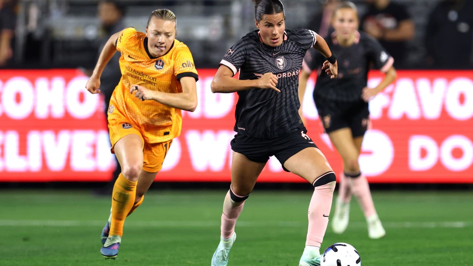 Two players competing during NWSL match Two players competing during NWSL match