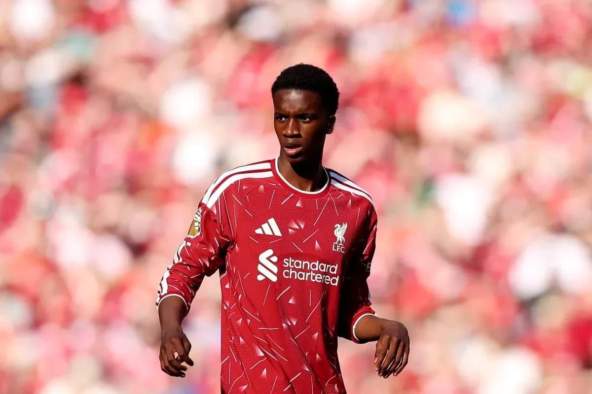 Player in red Liverpool kit on the field Player in red Liverpool kit on the field