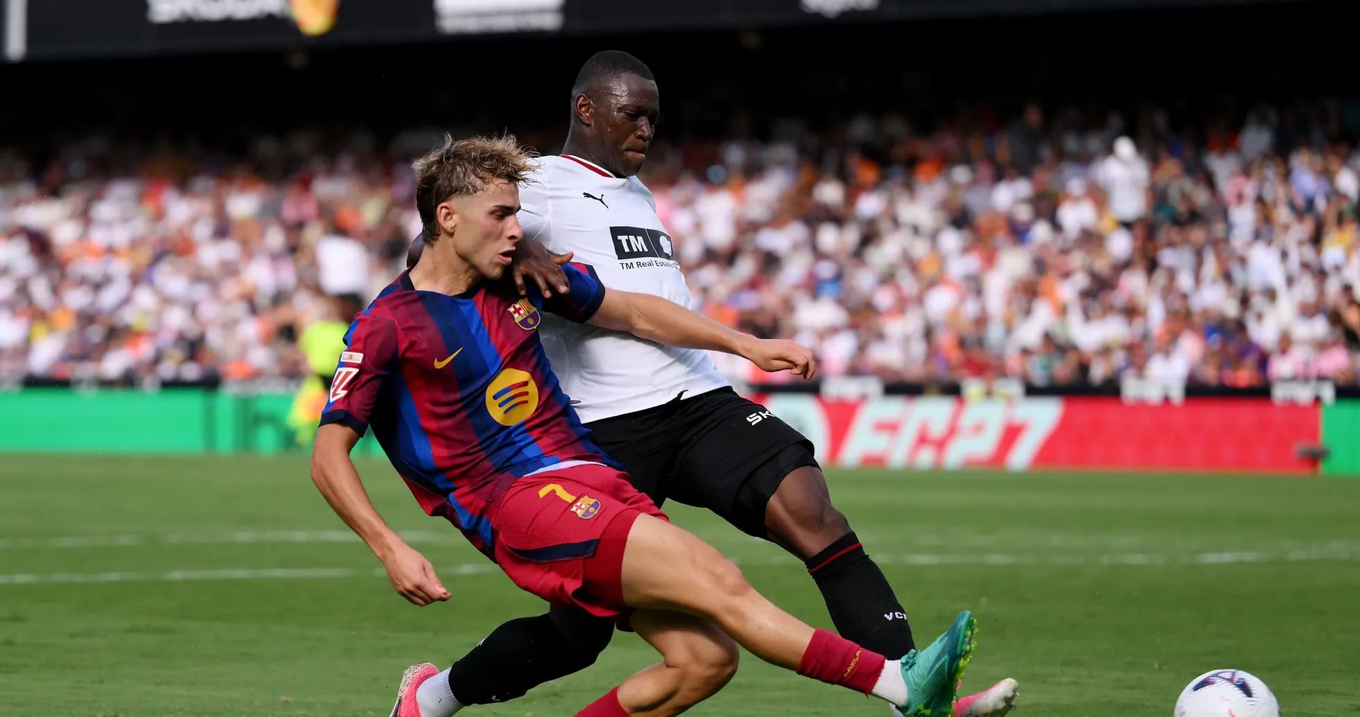 Player from Barcelona tackling opponent during match Player from Barcelona tackling opponent during match
