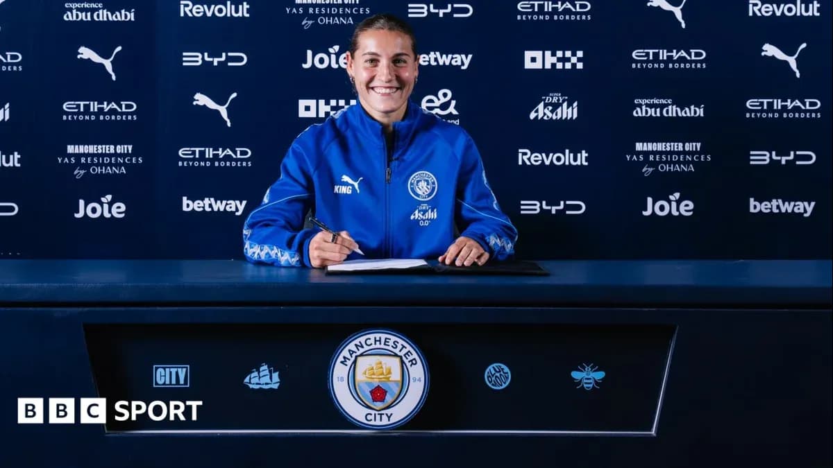 Player signing contract at Manchester City press table Player signing contract at Manchester City press table